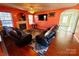 Living room with fireplace, hardwood floors, and leather furniture at 8024 Bronze Pike Dr, Charlotte, NC 28273