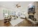 Spacious living room with stone fireplace, hardwood floors, and ample natural light at 8130 Clems Branch Rd, Fort Mill, SC 29707