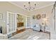 Home office with French doors, chandelier, and built-in shelving at 8130 Clems Branch Rd, Fort Mill, SC 29707