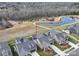 Aerial view of homes in the neighborhood featuring a pond and walking trail nearby at 9029 Treetop Nw Way, Concord, NC 28027