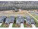 Aerial view of homes in the neighborhood featuring a pond and walking trail nearby at 9029 Treetop Nw Way, Concord, NC 28027