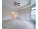 An empty bedroom showcases a ceiling fan and a view to an ensuite bathroom that is ready to personalize at 9029 Treetop Nw Way, Concord, NC 28027