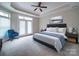 Well-appointed bedroom with a tray ceiling, ceiling fan, and a stylishly furnished bed, creating a cozy retreat at 9029 Treetop Nw Way, Concord, NC 28027