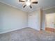 A comfortable empty bedroom featuring a closet and doorway to an attached bathroom at 9029 Treetop Nw Way, Concord, NC 28027