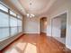 Dining area with hardwood floors, large windows with natural light, and a modern chandelier at 9029 Treetop Nw Way, Concord, NC 28027