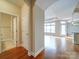 Spacious entryway with gleaming hardwood floors leading to an open-concept living area and a conveniently located powder room at 9029 Treetop Nw Way, Concord, NC 28027