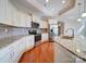 Bright kitchen featuring stainless steel appliances, granite countertops, and ample cabinet space at 9029 Treetop Nw Way, Concord, NC 28027