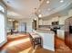 Bright kitchen with granite countertops, stainless steel appliances, bar stool seating and hardwood floors at 9029 Treetop Nw Way, Concord, NC 28027