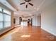 Bright open-concept living area featuring hardwood floors, recessed lighting, an eat-in kitchen and an arched doorway at 9029 Treetop Nw Way, Concord, NC 28027