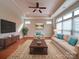 A beautifully staged living room with neutral-colored furniture, recessed lighting, and large windows at 9029 Treetop Nw Way, Concord, NC 28027