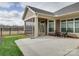 View of back patio area with small table and chairs overlooking a green lawn at 9029 Treetop Nw Way, Concord, NC 28027