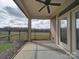 Porch with ceiling fan overlooking green space and black metal fence at 9029 Treetop Nw Way, Concord, NC 28027