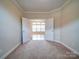 Neutral room with carpet that looks into a bigger room at 9029 Treetop Nw Way, Concord, NC 28027