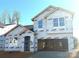 New construction home featuring a two-car garage, modern windows and protective Typar building wrap at 9842 Quercus Ln, Huntersville, NC 28078