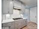 Modern kitchen with gray cabinets, white quartz countertops and stainless steel appliances at 9842 Quercus Ln, Huntersville, NC 28078