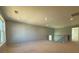 Spacious unfinished bonus room with natural light and access to stairwell at 9934 Cask Way, Huntersville, NC 28078