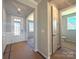 Entryway featuring neutral walls and trim, a view of the hallway and another room, and flooring protected during construction at 9934 Cask Way, Huntersville, NC 28078