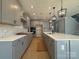 Spacious kitchen featuring gray cabinets, a large island, and modern lighting fixtures at 9934 Cask Way, Huntersville, NC 28078