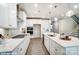 Bright kitchen features white cabinets, an island with a sink, stainless steel appliances, and pendant lighting at 9934 Cask Way, Huntersville, NC 28078