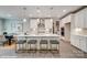 Open kitchen featuring white cabinets, a large island with seating, stainless steel appliances, and modern lighting at 9934 Cask Way, Huntersville, NC 28078