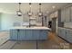 Kitchen featuring gray cabinets, an island, stainless steel appliances, and flooring protected during construction at 9934 Cask Way, Huntersville, NC 28078