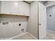 A laundry room with white cabinets and a separate door to another room at 9934 Cask Way, Huntersville, NC 28078