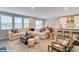 Bright and airy living room with large sectional sofa, modern decor, and kitchen in background at 9934 Cask Way, Huntersville, NC 28078