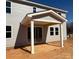 A covered patio with gray siding, white columns, a concrete surface, and sliding glass doors at 9934 Cask Way, Huntersville, NC 28078