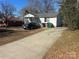 House with driveway and mature trees at 1004 Druid Cir, Charlotte, NC 28206