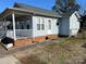 Side view of the house with a covered porch and brick base at 1004 Johnson St, Charlotte, NC 28206