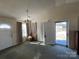 Bright living room with carpeting, a ceiling fan, and access to the porch at 1004 Johnson St, Charlotte, NC 28206