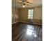 Room with window, wall unit, and vinyl flooring at 1019 W 5Th Ave, Gastonia, NC 28052