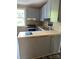 L-shaped kitchen with gray cabinets and a tiled counter at 1019 W 5Th Ave, Gastonia, NC 28052