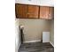 Laundry area with wooden cabinets and vinyl flooring at 1019 W 5Th Ave, Gastonia, NC 28052