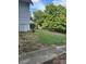 Property includes a grassy side yard with a concrete walkway at 1019 W 5Th Ave, Gastonia, NC 28052