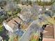 An aerial view of the neighborhood highlighting the homes with mature trees and well-maintained lawns at 10433 Pullengreen Dr, Charlotte, NC 28277