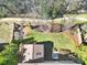 An overhead shot of the backyard showing the lawn, landscaping, bordering fence, trees and patio area at 10433 Pullengreen Dr, Charlotte, NC 28277