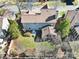 Aerial view of the home showcasing the lawn, patio, fence and mature trees at 10433 Pullengreen Dr, Charlotte, NC 28277