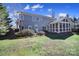 This backyard showcases lush landscaping, a screened-in porch, and a well-maintained lawn at 10433 Pullengreen Dr, Charlotte, NC 28277