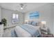 Cozy bedroom with a ceiling fan, shuttered window, and soft blue accents at 10433 Pullengreen Dr, Charlotte, NC 28277