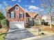 Beautiful brick home with a well-manicured lawn, an attached garage and mature landscaping at 10433 Pullengreen Dr, Charlotte, NC 28277