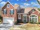 Attractive brick home with a two-car garage, mature landscaping and a covered front porch at 10433 Pullengreen Dr, Charlotte, NC 28277