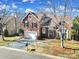 Charming brick home featuring a manicured front yard, a two-car garage, and a welcoming entryway at 10433 Pullengreen Dr, Charlotte, NC 28277