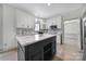 Modern kitchen with white cabinets, a large island, and an abundance of natural light at 10433 Pullengreen Dr, Charlotte, NC 28277