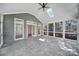 A vaulted ceiling and expansive windows define this gray sunroom with tiled flooring at 10433 Pullengreen Dr, Charlotte, NC 28277