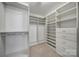 Spacious walk-in closet featuring built-in shelving, drawers, and ample storage space at 10433 Pullengreen Dr, Charlotte, NC 28277