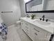 This modern bathroom features a double sink vanity at 10904 Pimlico Dr, Charlotte, NC 28273