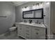 This modern bathroom features a double sink vanity and modern lighting at 10904 Pimlico Dr, Charlotte, NC 28273