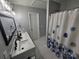 This bright bathroom features a double sink and a shower at 10904 Pimlico Dr, Charlotte, NC 28273