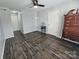 Bright bedroom features hardwood-look floors, a ceiling fan, and modern neutral paint at 10904 Pimlico Dr, Charlotte, NC 28273